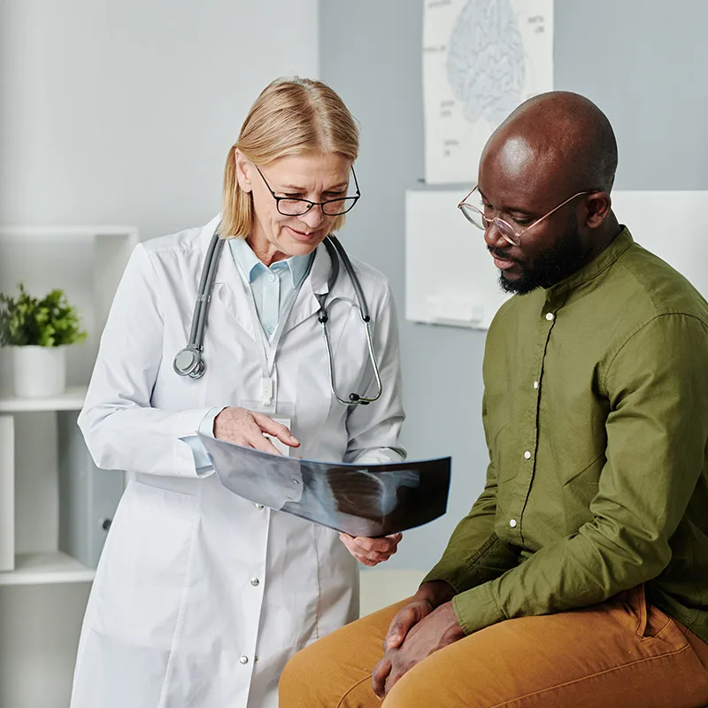 Doctor reviewing an X-ray with a patient, representing Trillium Estates amenities with convenient healthcare facilities and services.