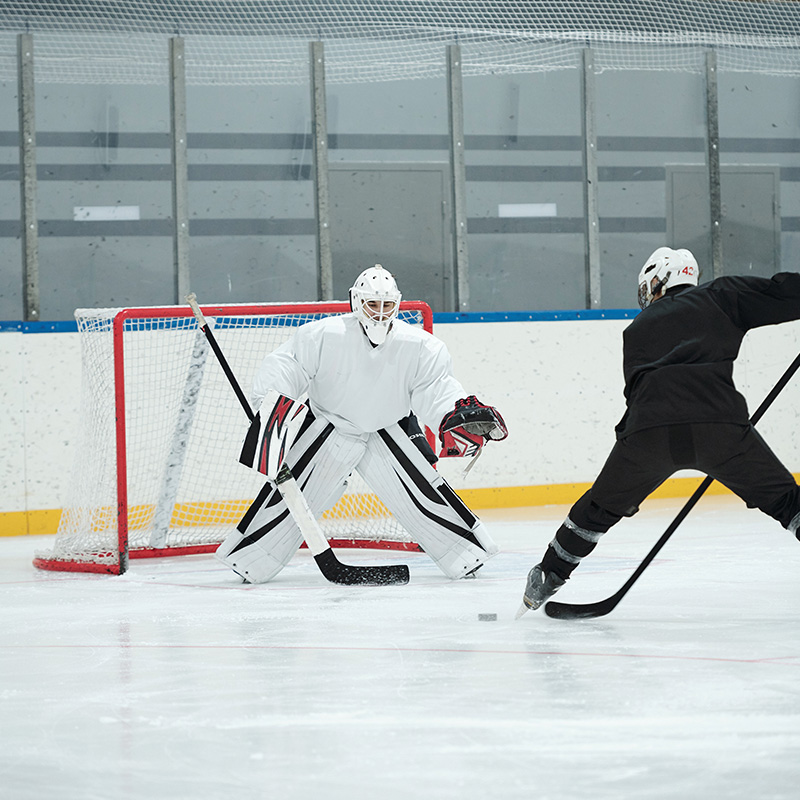 Hockey players in action on an ice rink, highlighting Trillium Estates amenities with access to sports facilities and recreation.